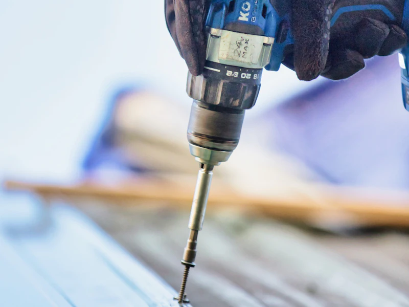 Driving a fastener into roof decking, close-up — representative